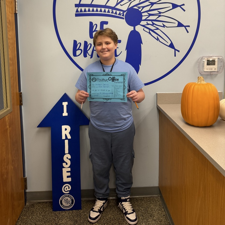 student holding Positive Office Referral