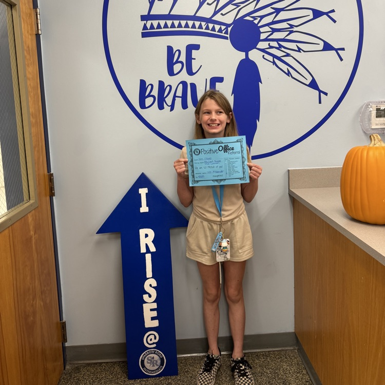 student holding Positive Office Referral