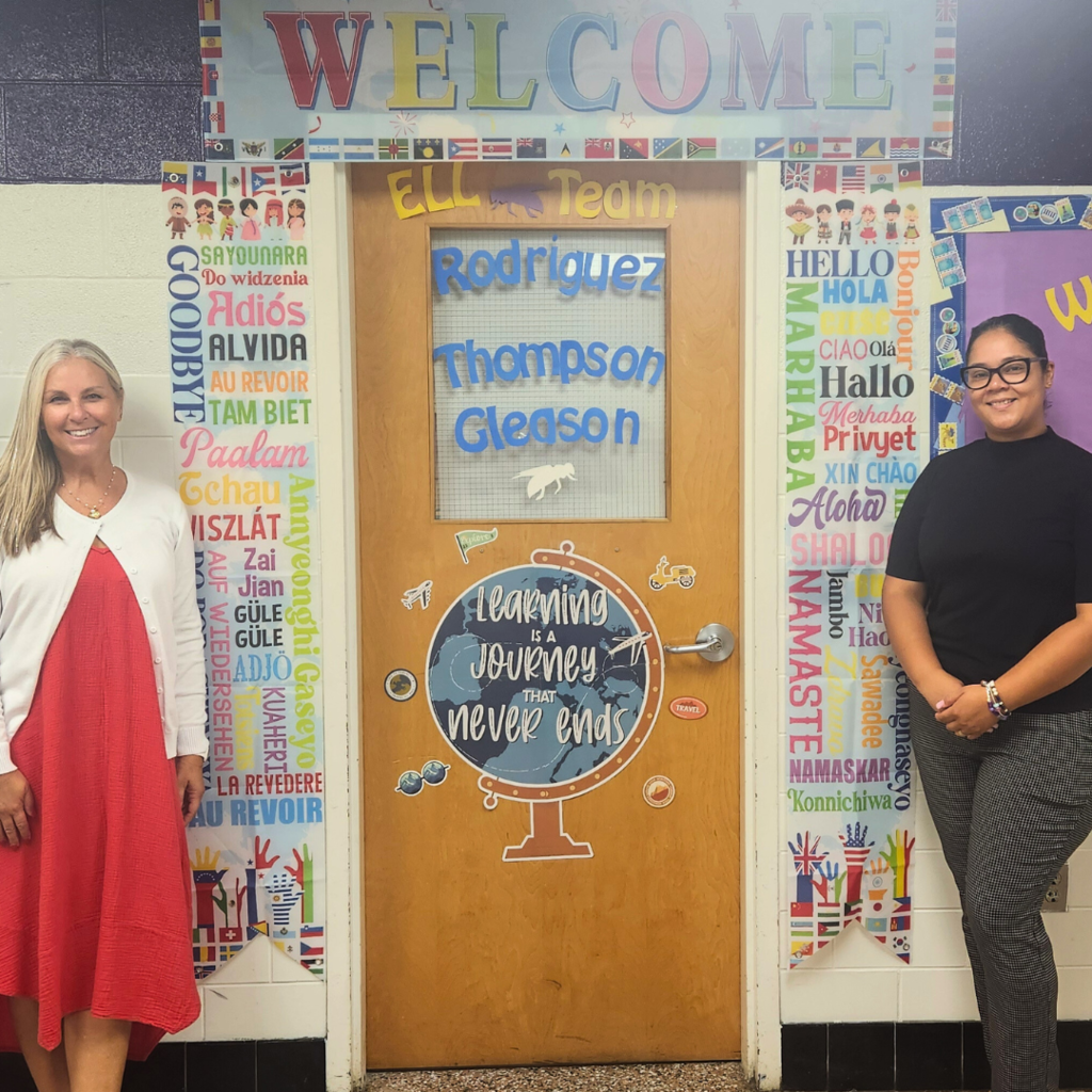 Mrs. Rodriquez and Mrs. Thompson standing by their door