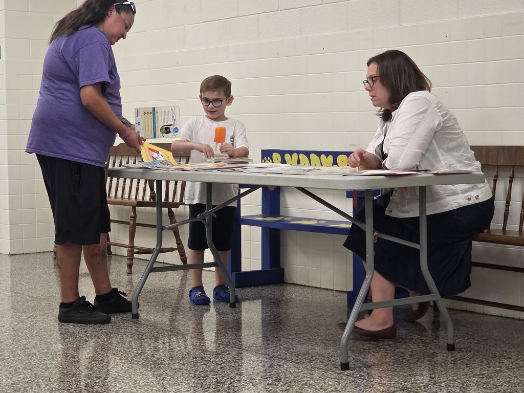 Student picking up a free book with Mrs. Steadman