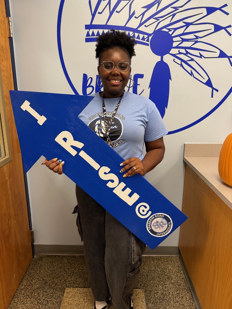Mrs. Tynes with RISE sign