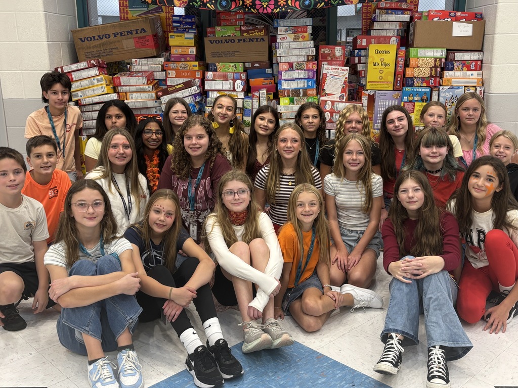 students with cereal boxes in the backround