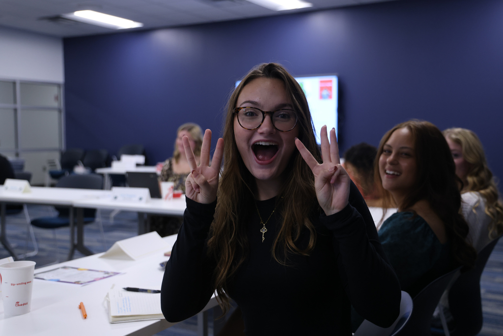student leader holding ups 6 fingers 