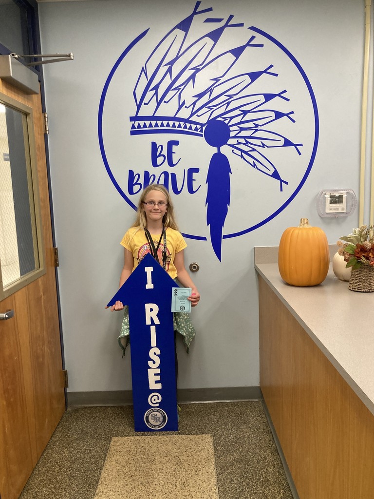 Student with RISE Recognition sign