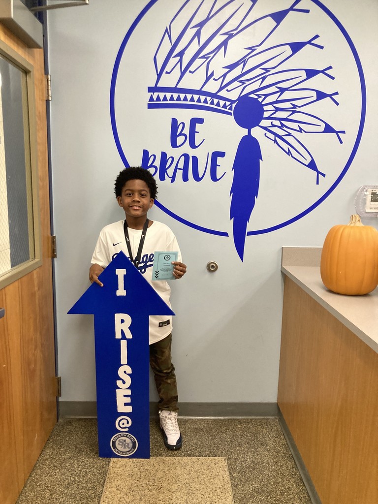 Student with RISE Recognition sign
