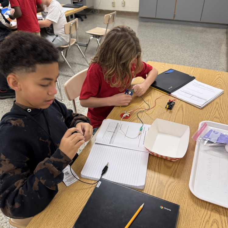 students working together to make a closed circuit
