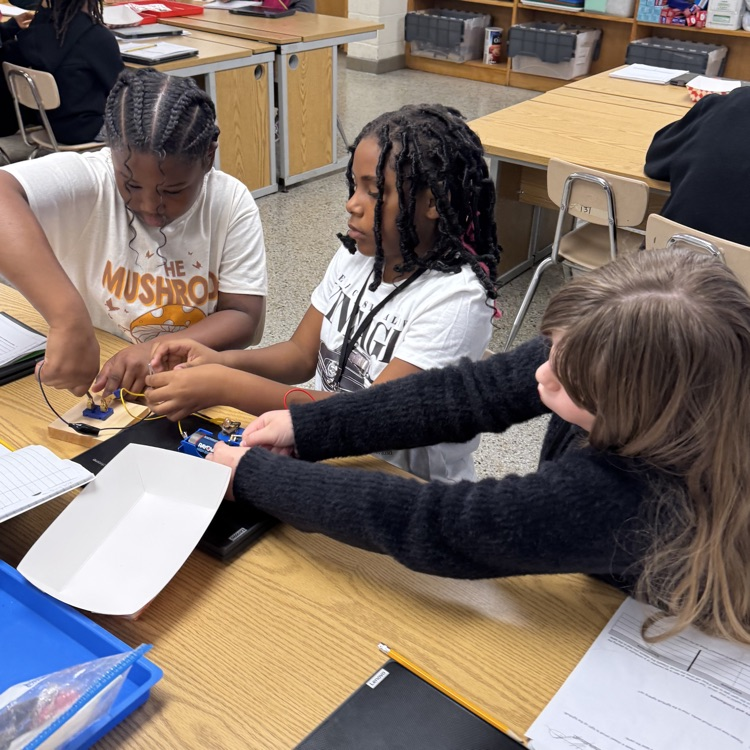 students working together to make a closed circuit