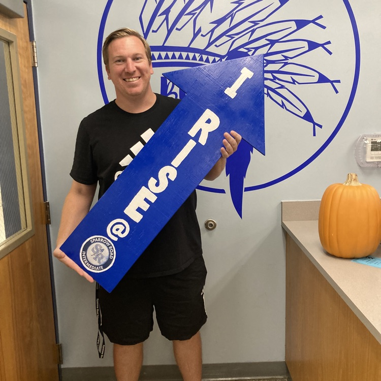 Mr. Delbridge with RISE sign