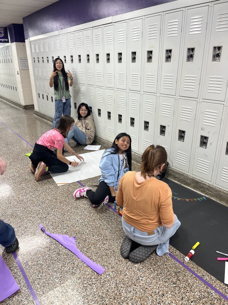 Students working on antibullying month posters.