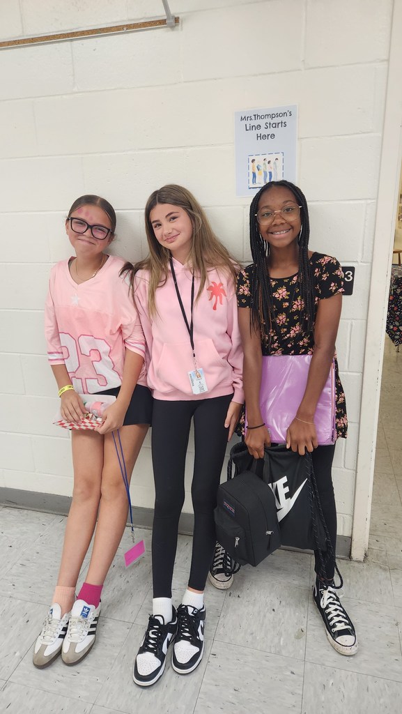 Three students in pink or Spirit Day