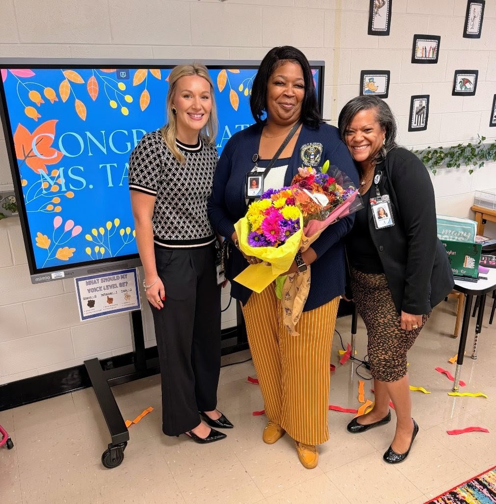teacher of the year standing with adminstrators