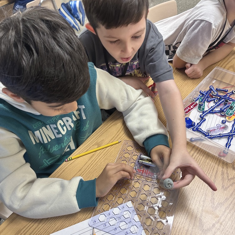 students using snap circuits to make something move
