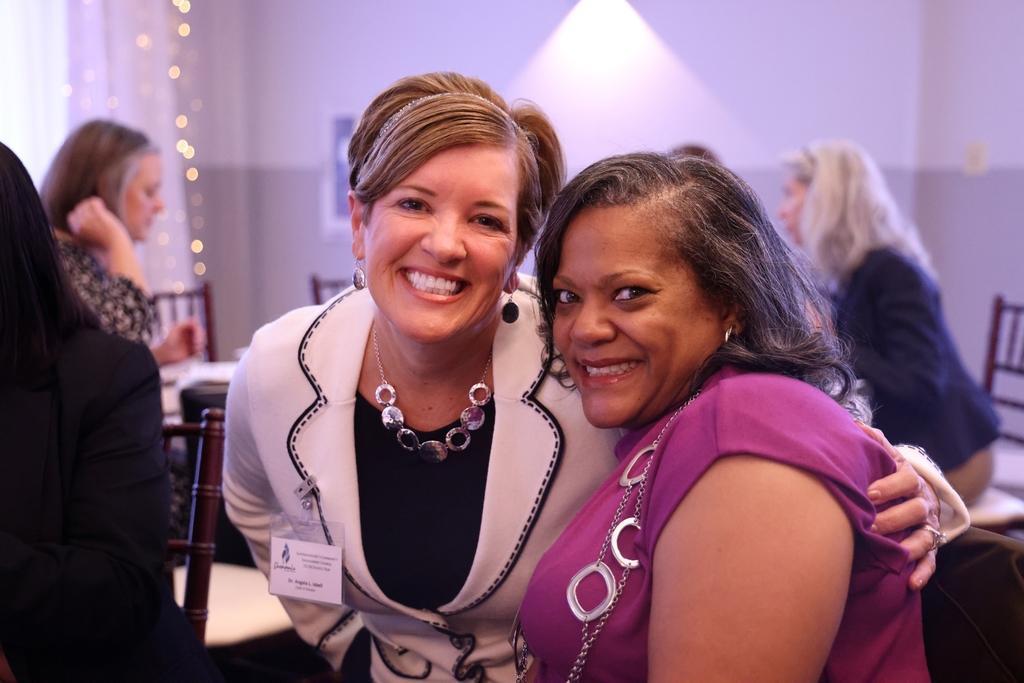 School and administrative leaders smiling.