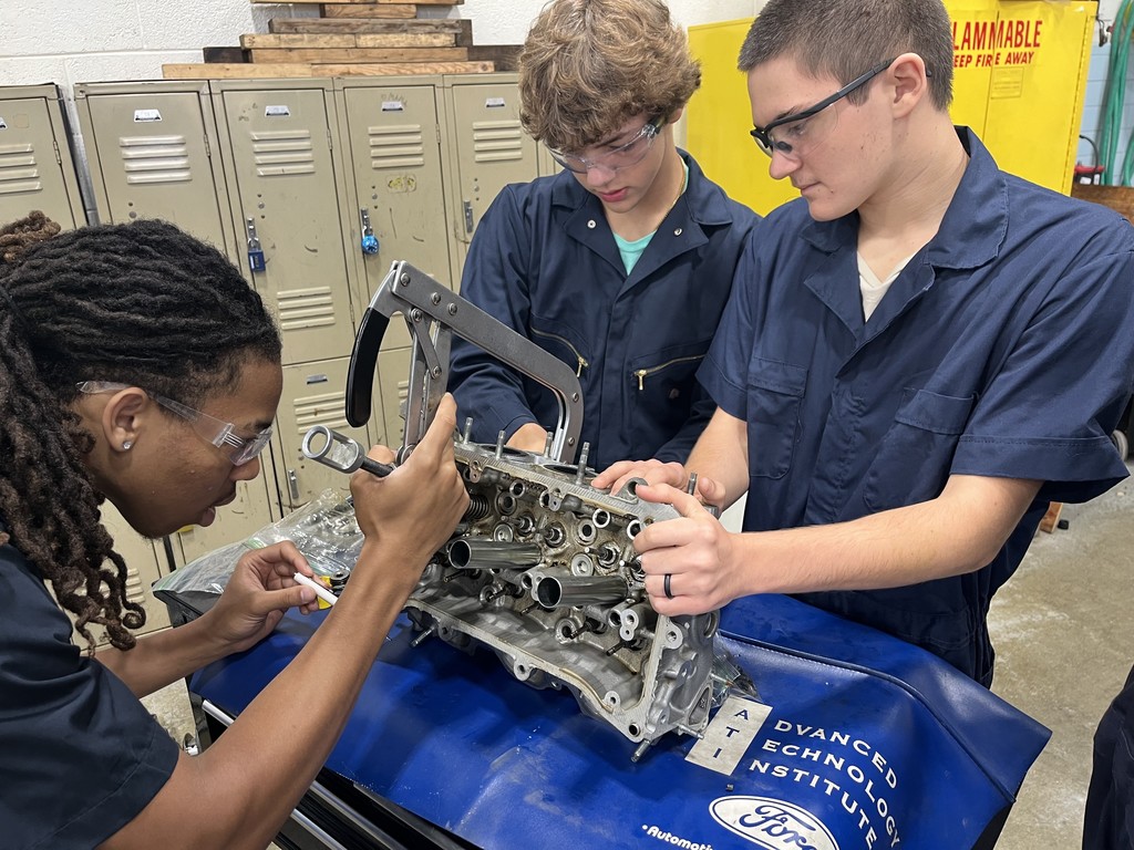 Students working on engine disassembly and reassembly 