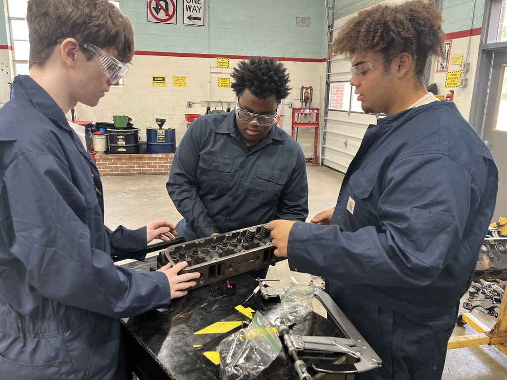 Students working on engine disassembly and reassembly 
