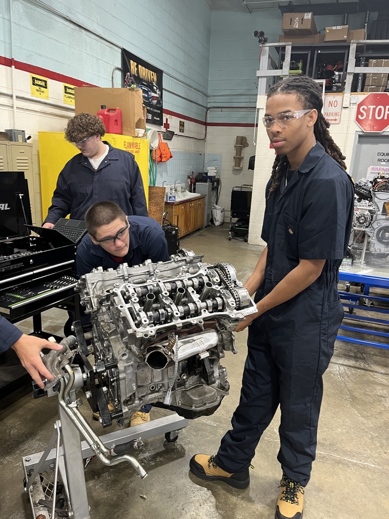 Students working on engine disassembly and reassembly 