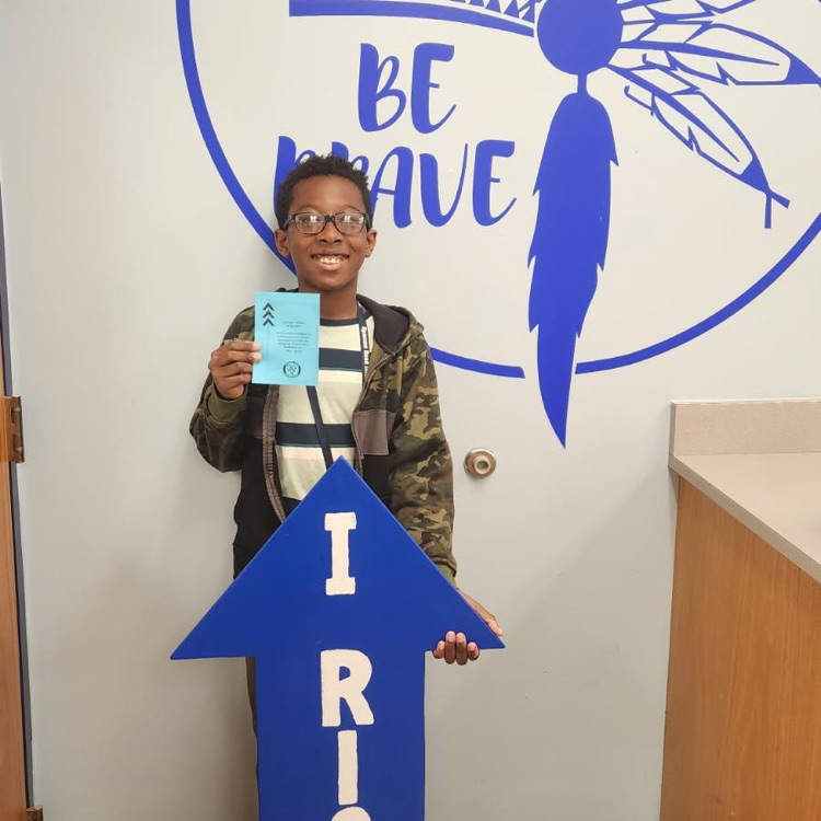 student with I RIsE sign