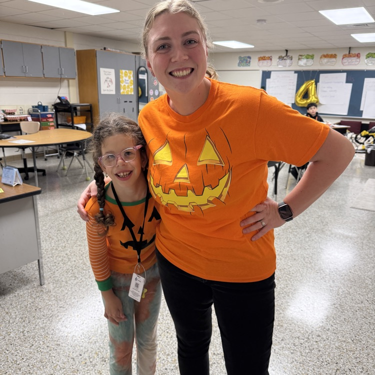 student and teacher with pumpkin shirts