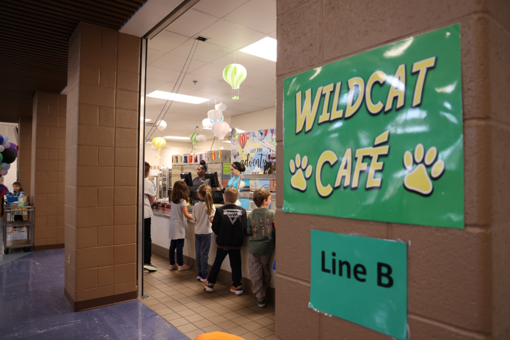 Kids in line at lunch wildcat cafe sign