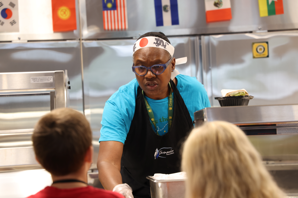 lunch worker talking to kids