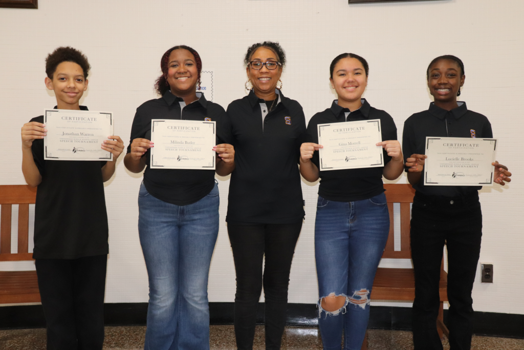 students holding up certificates