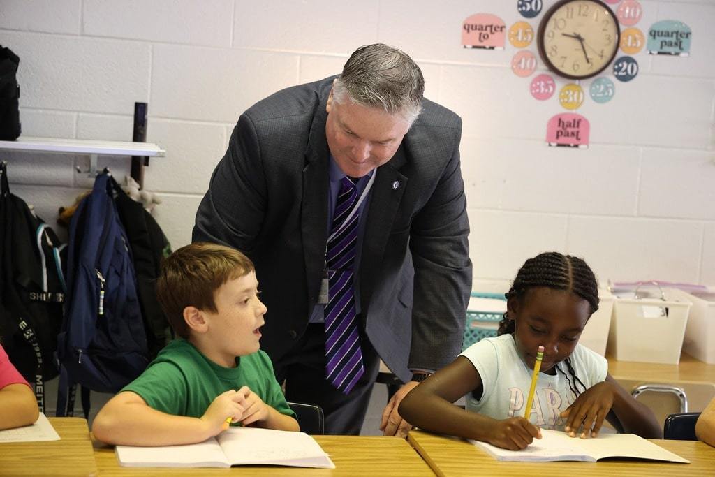 Dr. Cotton talking with elementary students