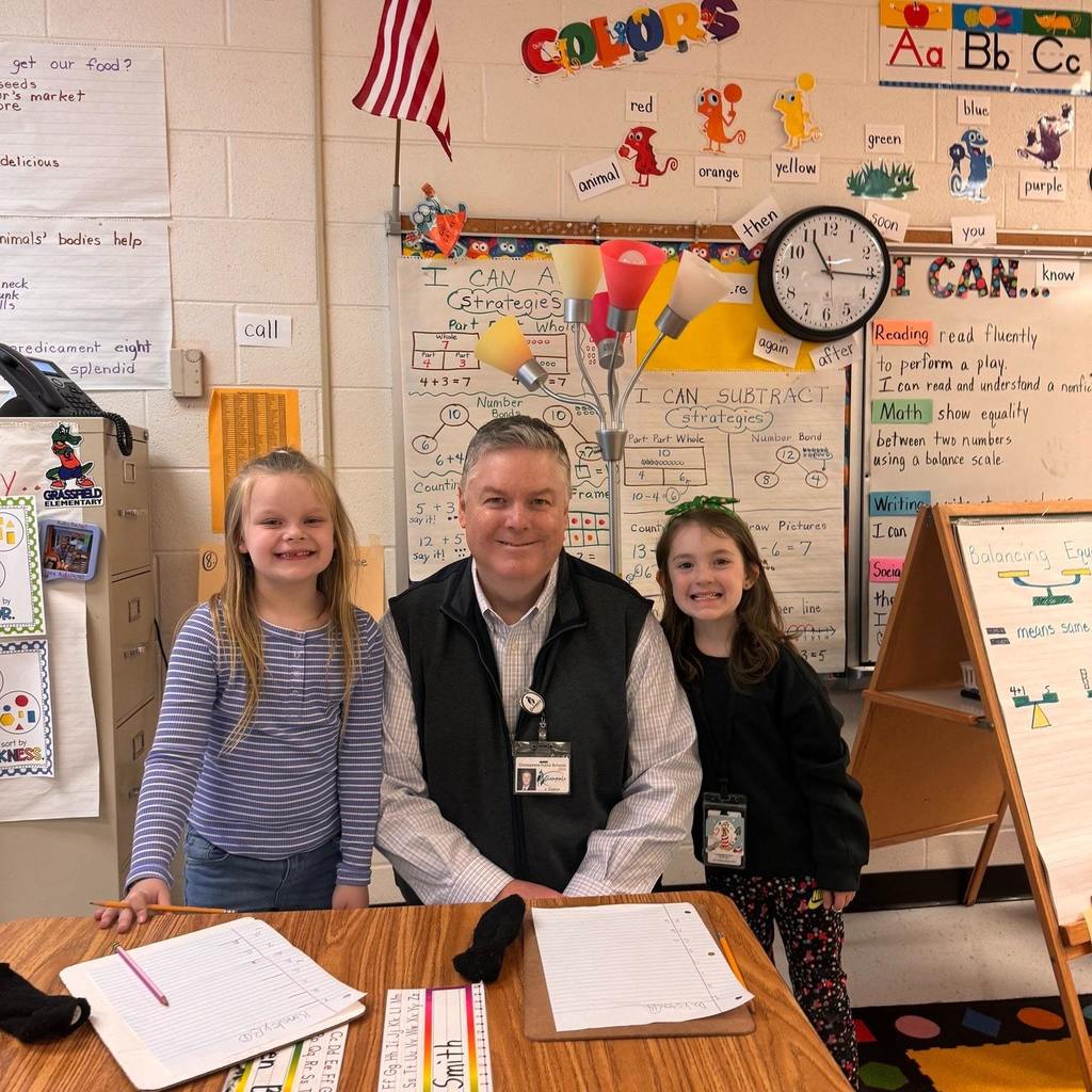 Dr. Cotton posing with elementary students