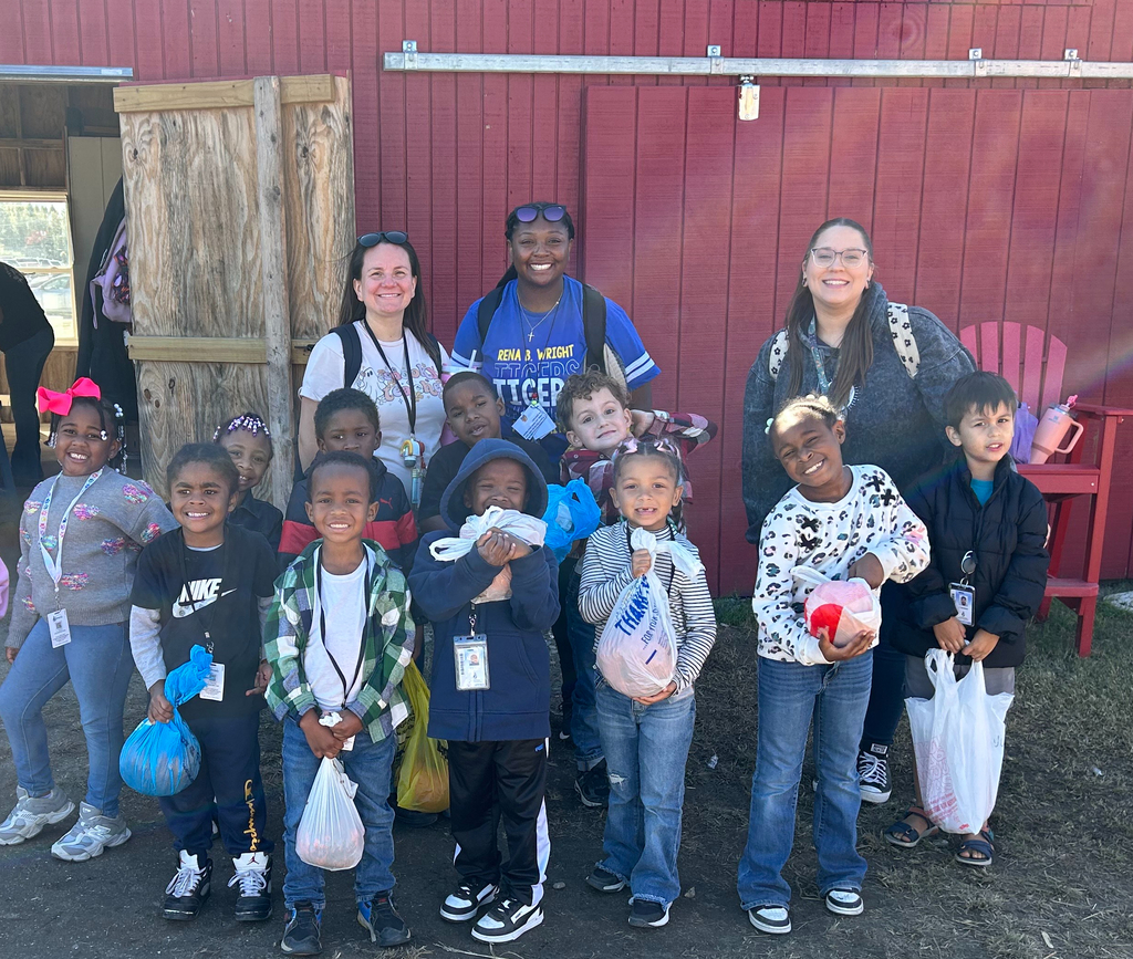 Mrs. Childs, Mrs. White and Ms. Thompson with students at the farm with pumpkins