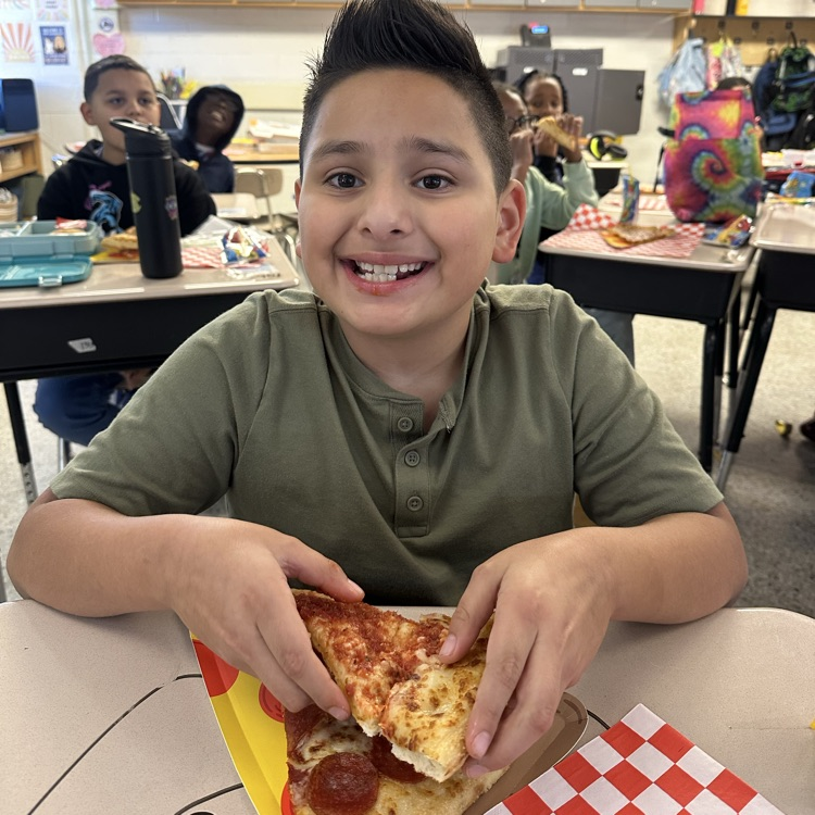 student with slice of pizza and pizza plate