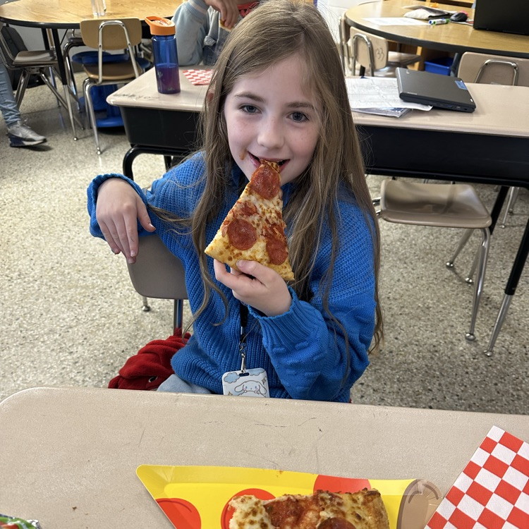 student with slice of pizza and pizza plate