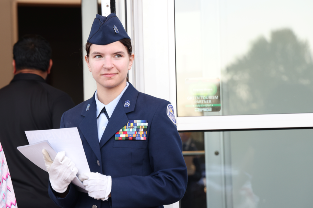 JROTC student smiling passing out flyers