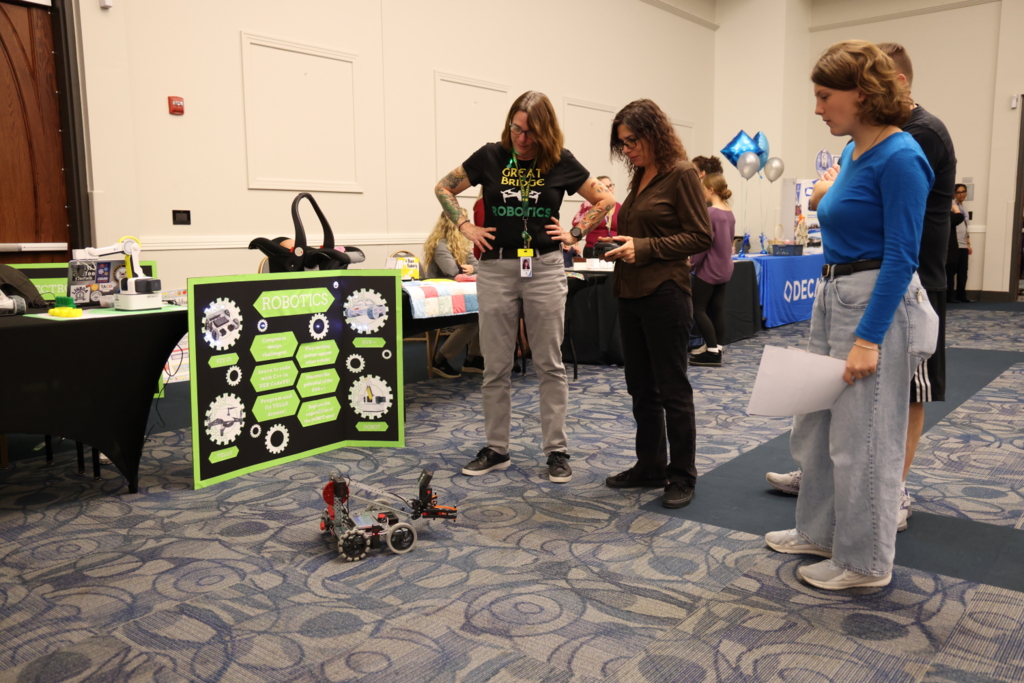 student and parents playing with robot car
