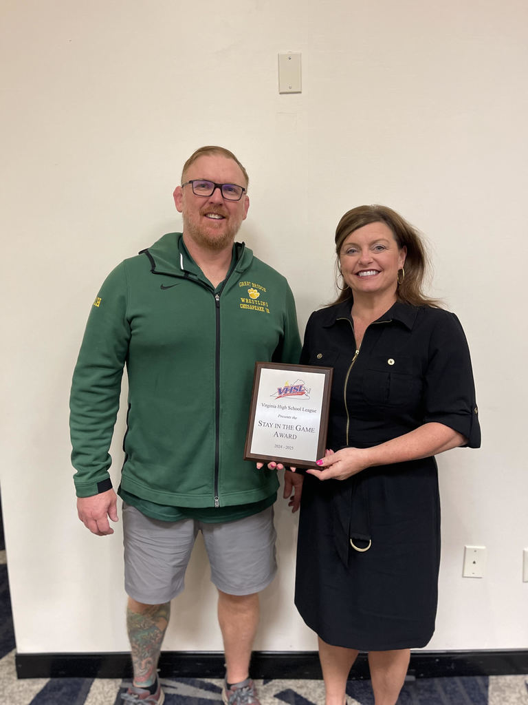 GBHS wrestling coach and principal smiling with award