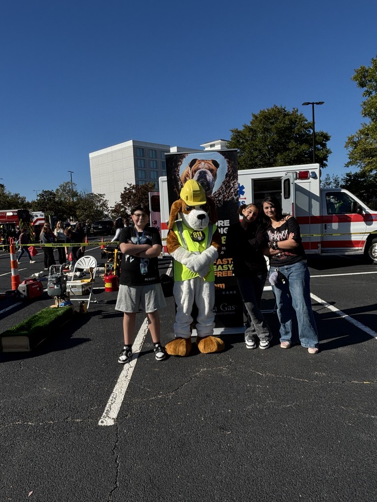 Students Smiling with Firefighter mascot- Dog