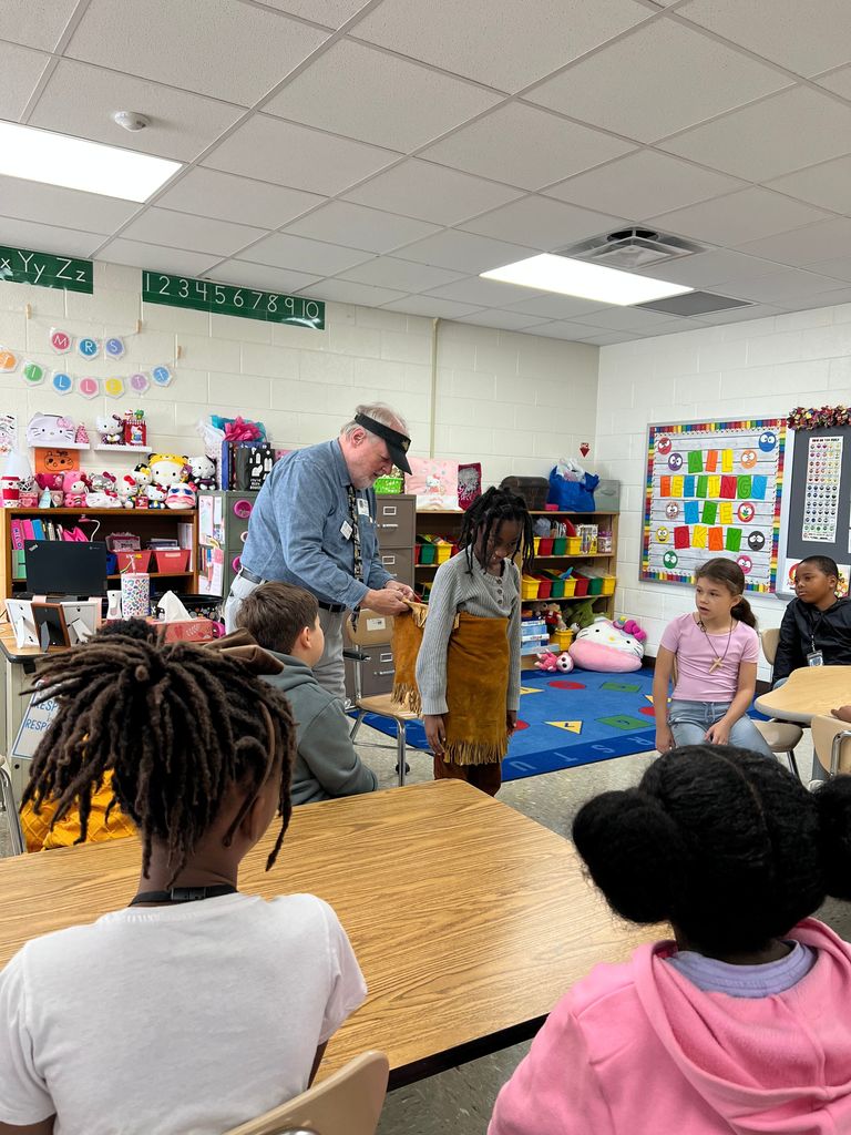 2nd grade with  Jamestown presenter wearing Powhatan clothing