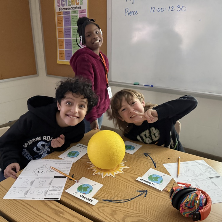 students with model of season