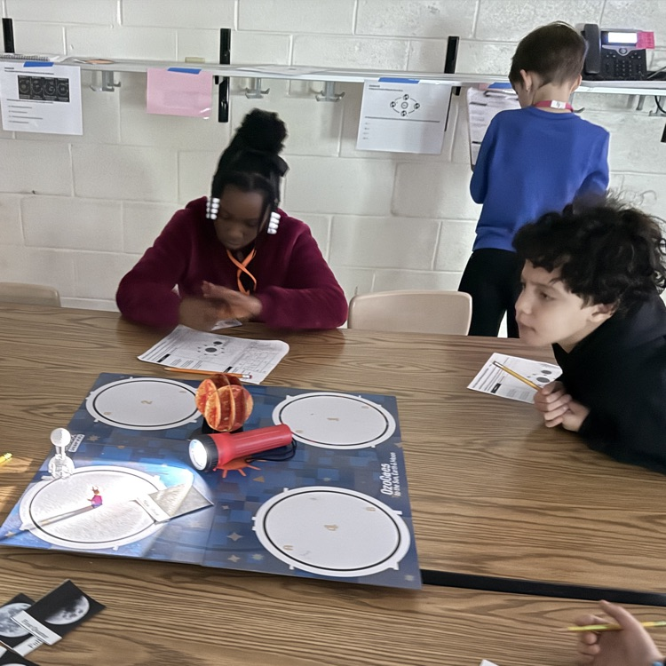 students with moon phases model 