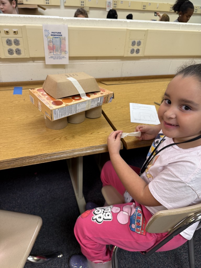 student posing with her sun-blocking structure