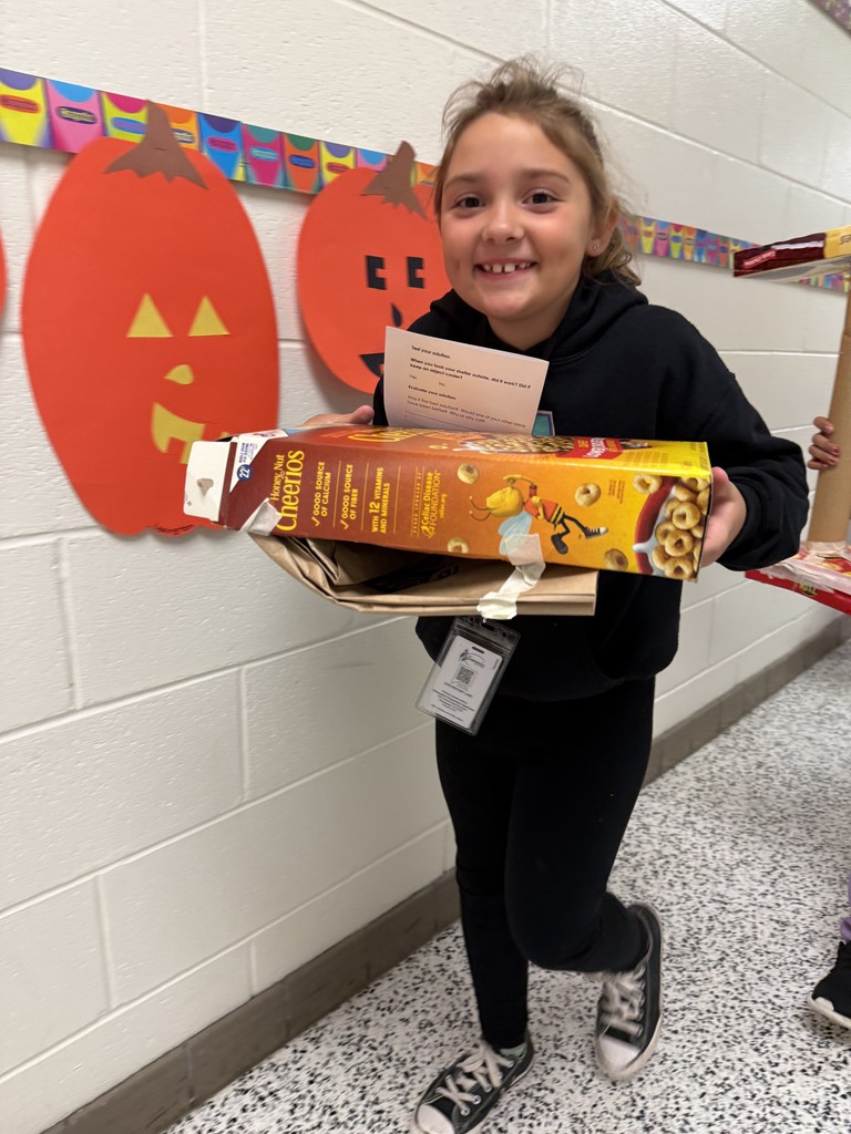 student carrying her completed sun-blocking structure