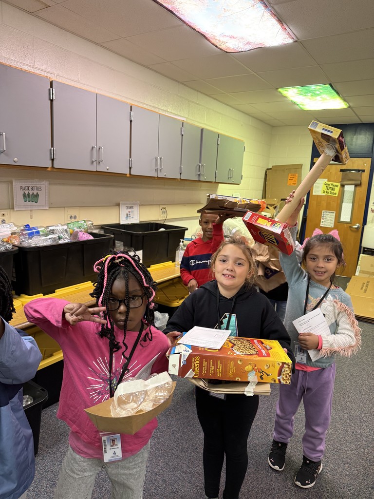students in line holding their sun-blocking structures