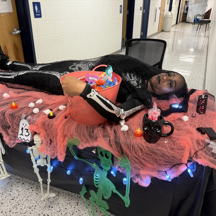 Skeleton costume laying on table with candy