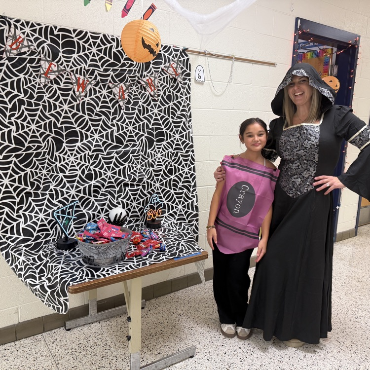 spider web display with teacher dressed up with child dressed in a crayon costume 