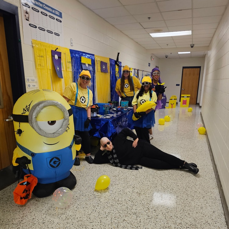 Minions themed costumes, table, and hallway