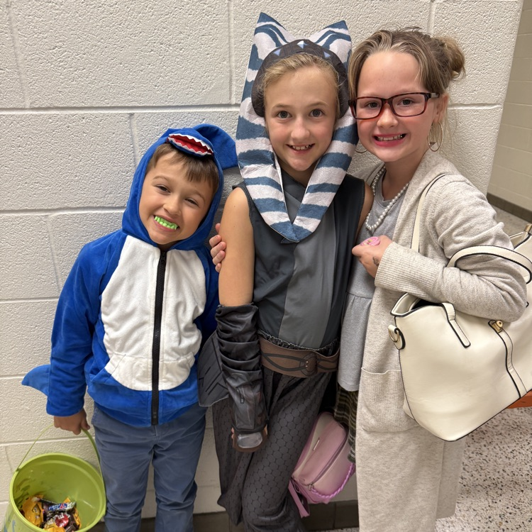 students in costumes with candy bags 
