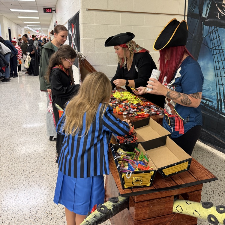 families getting candy from the pirate themed table 