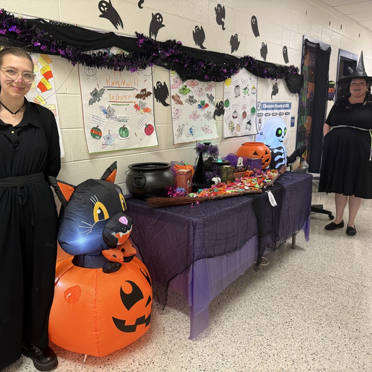 witch costumes with pumpkin cat blow up and themed table