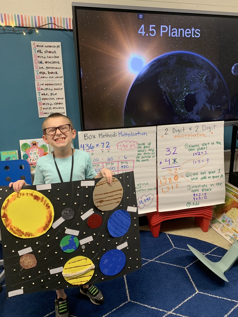 student holding solar system project