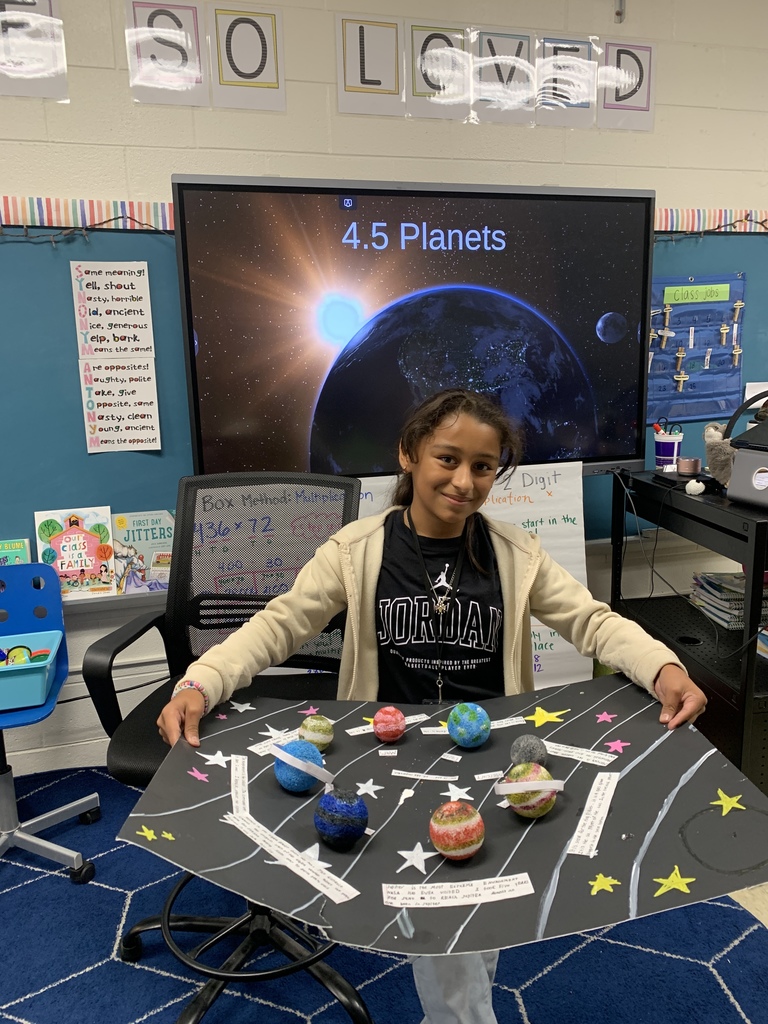 student holding solar system project