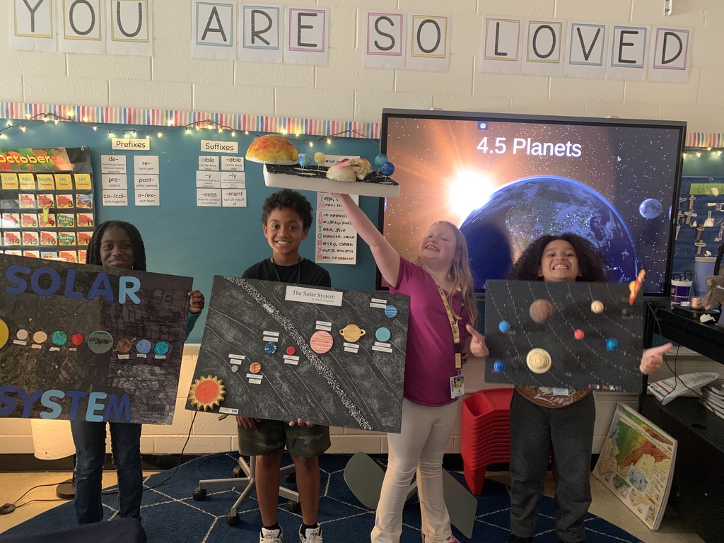 students holding solar system projects