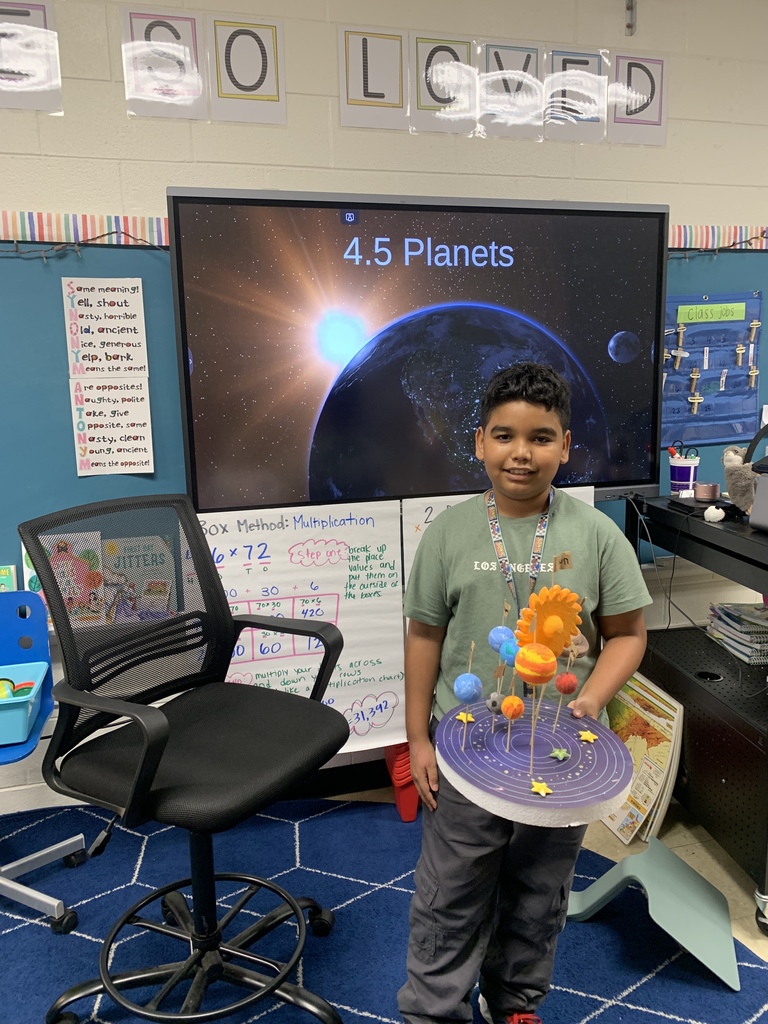 student holding solar system project